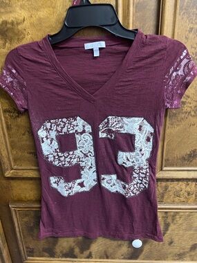 dELiA*s Maroon V-Neck Tee with White Lace '93' Graphic